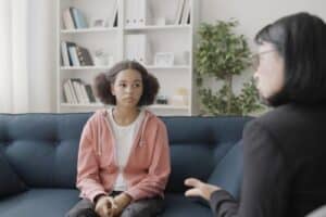 young person in grief and loss therapy with compassionate counselor
